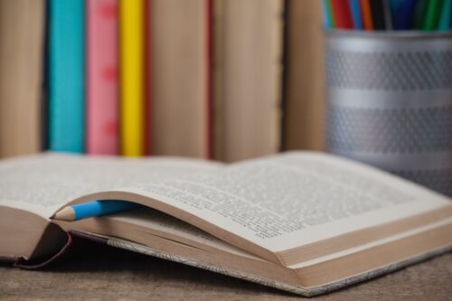 An open book on a desk. (Photo by wavebreak3, Adobe Stock)