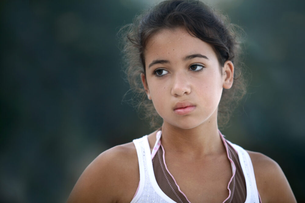 Teenage girl looking off to the side.