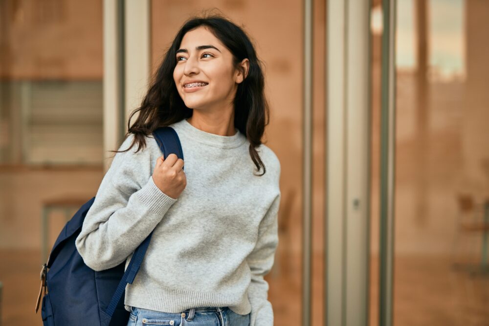 Smiling teen girl with a backpack.