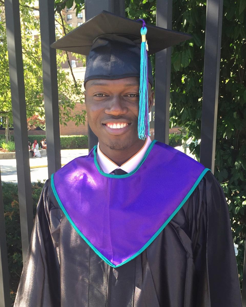 cheick in cap and gown on graduation day