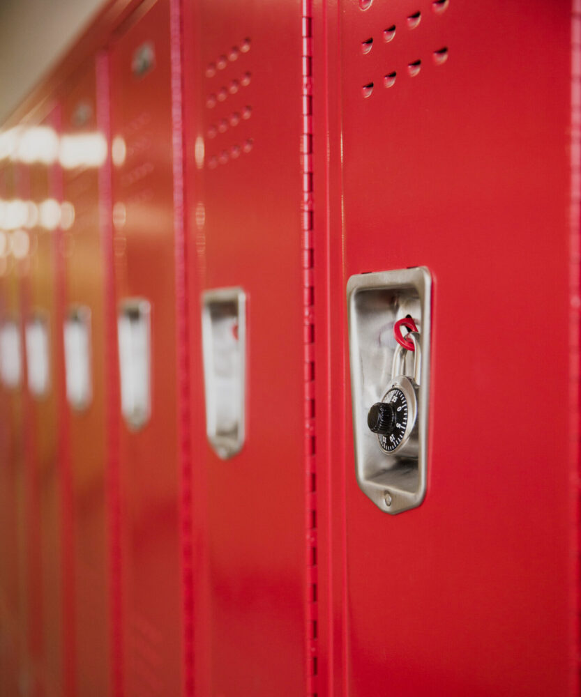 Red lockers in a school hallway. (Photo by Cavan for Adobe, Adobe Stock)