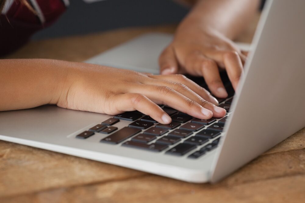 Hands typing on a laptop. (Photo by wavebreak3, Adobe Stock)