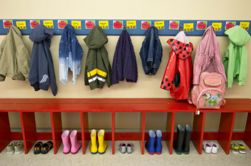 Preschoolers’ jackets and boots or shoes are lined up in their cubbies. Mayor Eric Adams has proposed cutting a pilot program that has provided free child care to 600 undocumented immigrant children this year.
