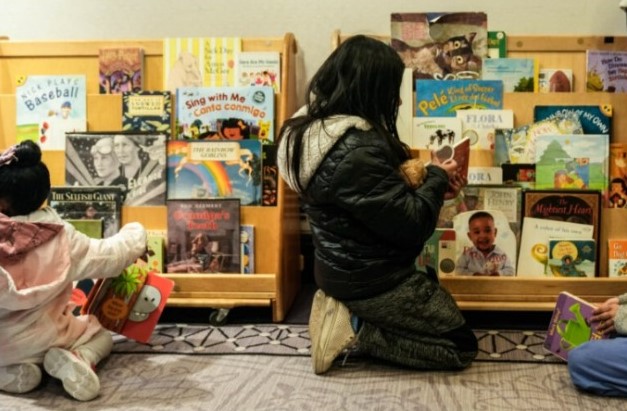 Kids peruse books donated to asylum-seekers at a city-sponsored event in March.