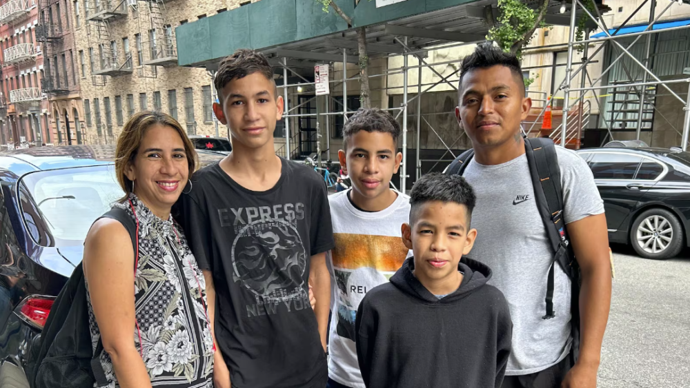 Norberto Priceño, right, poses for a photograph with his family in Manhattan. Two of his three children were still waiting for school assignments with the start of classes under two weeks away.