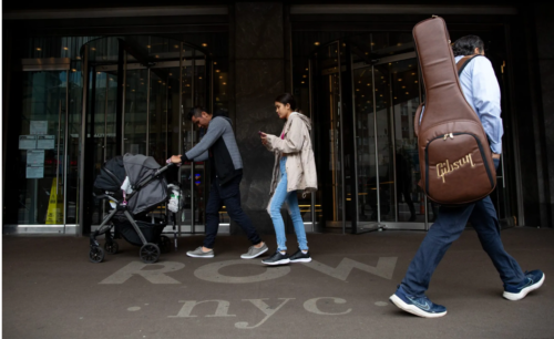 A family leaves the Row NYC migrant shelter in Times Square.
