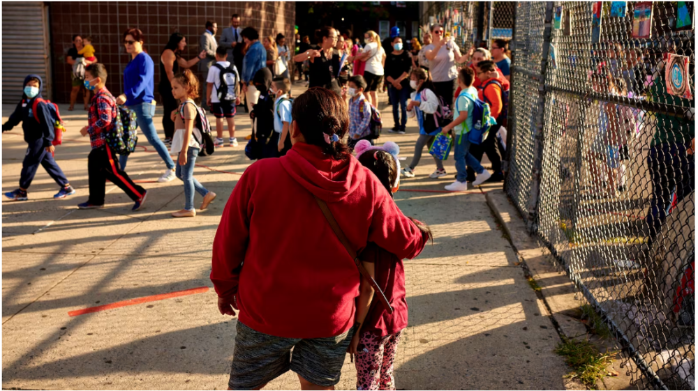 Students line up outside of P.S. 503 in Brooklyn in 2022. Families across the city will quickly feel the impact of $547 million in cuts to the New York City Education Department's budget.