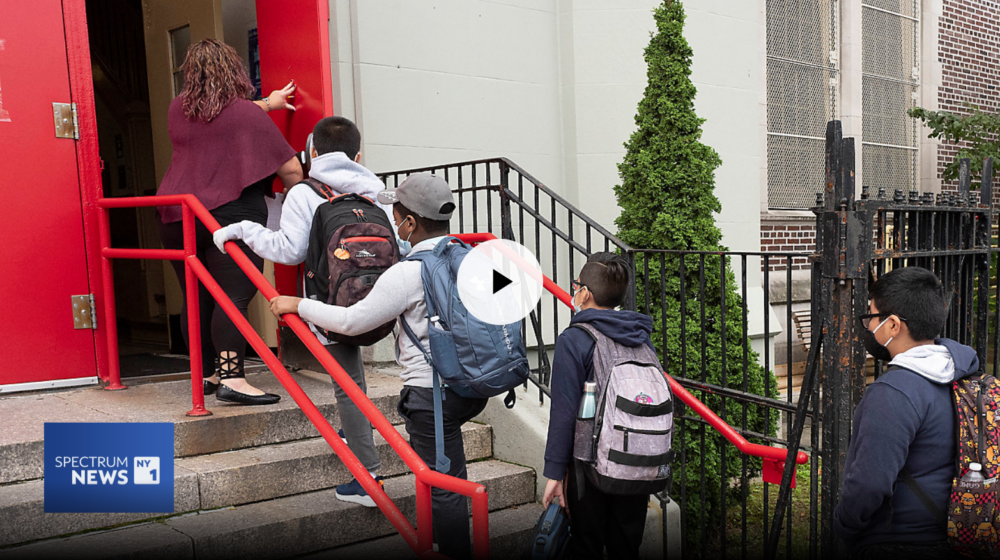 A teacher leads her students into an elementary school in Brooklyn on Sept. 29, 2020.