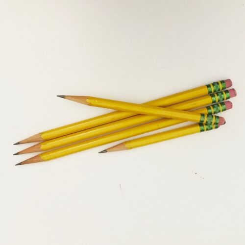 Five yellow pencils of varying lengths against a white background.