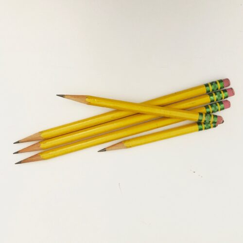 Five yellow pencils of varying lengths against a white background.