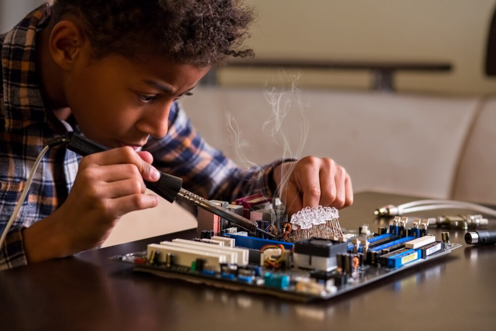 A boy repairing a motherboard