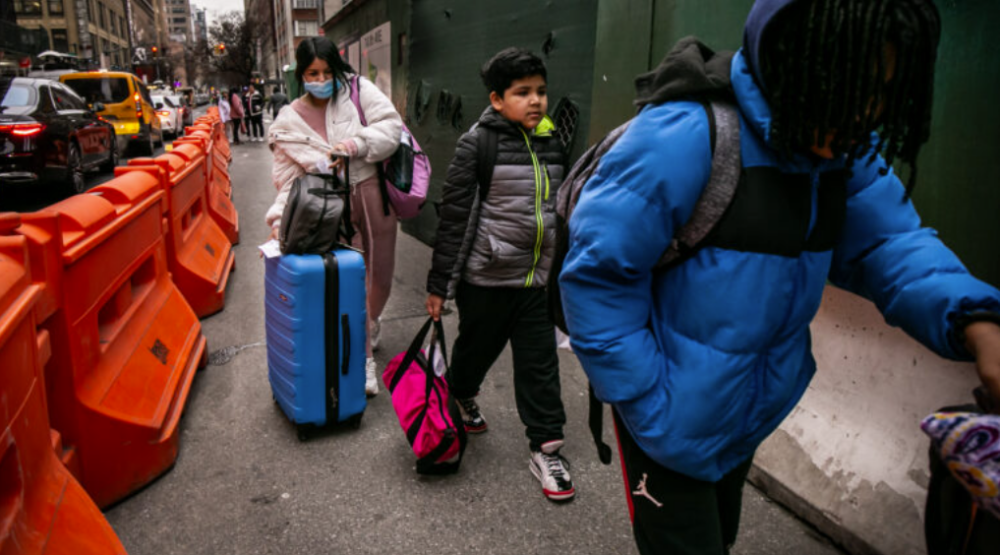 Elizabeth Leon and her two children on their way to reapply for another shelter placement after their deadline expired on Jan. 9.