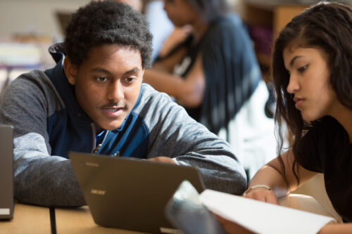 A ninth-grade student explains a new algebraic concept to his classmate.