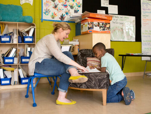 Female teacher working with a male first-grade student
