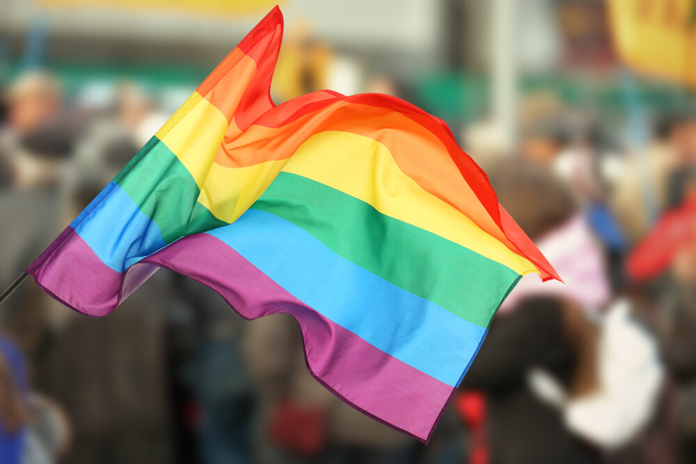 Pride flag. Blurred background of a crowd of people.