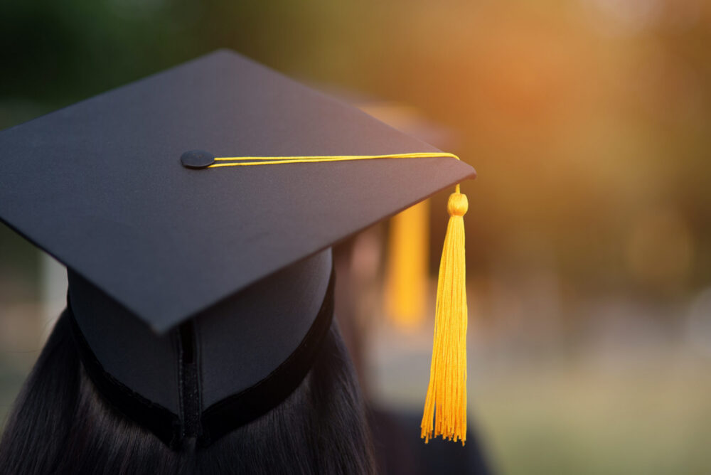 Back portrait of graduate wearing a black hat.