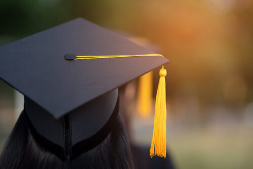 Back portrait of graduate wearing a black hat.