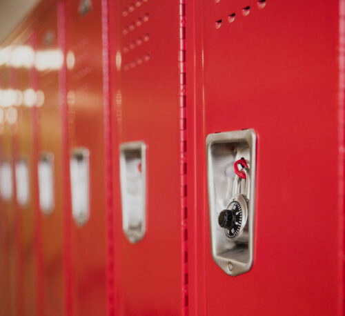 Red lockers in a school hallway.