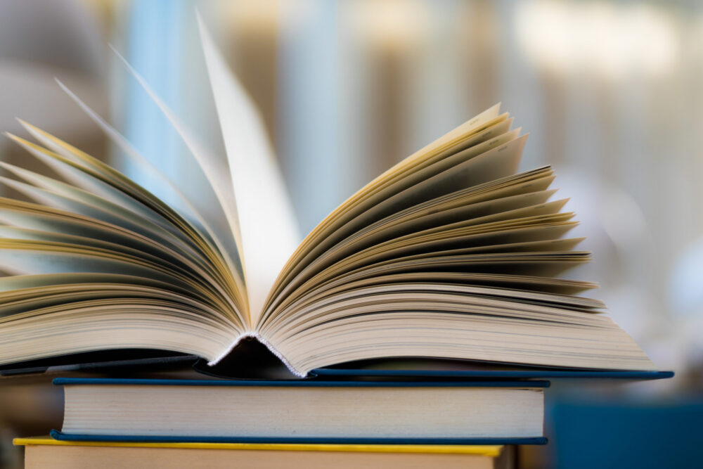 Open book lying on the table in the public library.