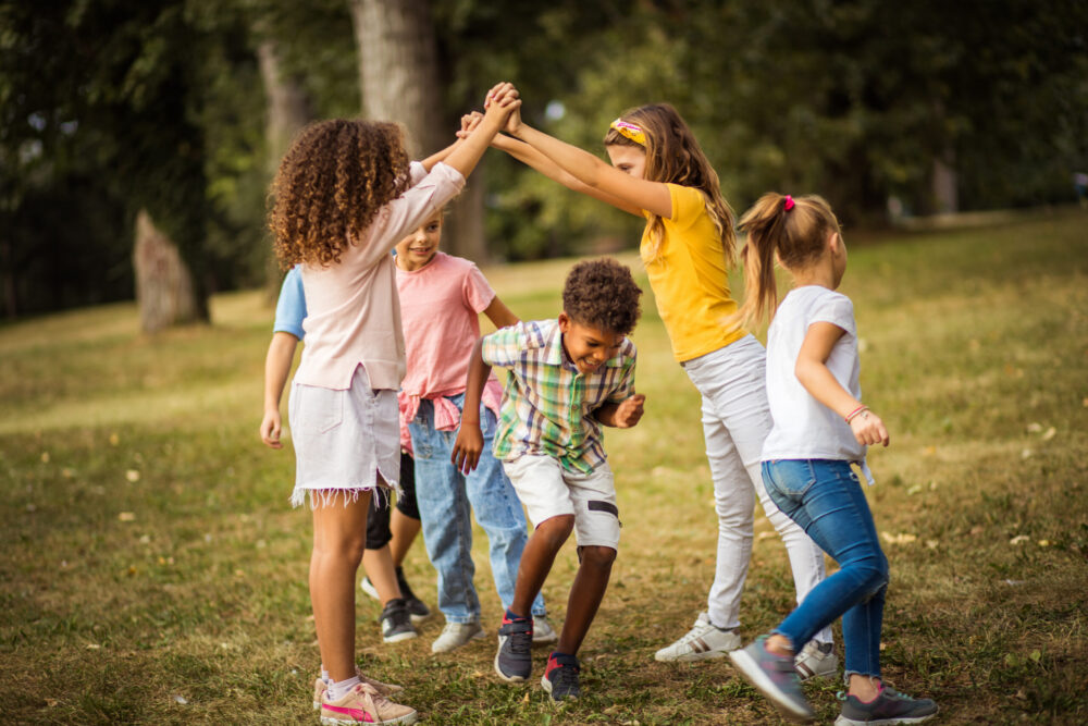 Large group of school kids having fun in nature.