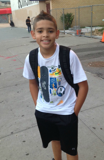 jake in front of school building wearing backpack