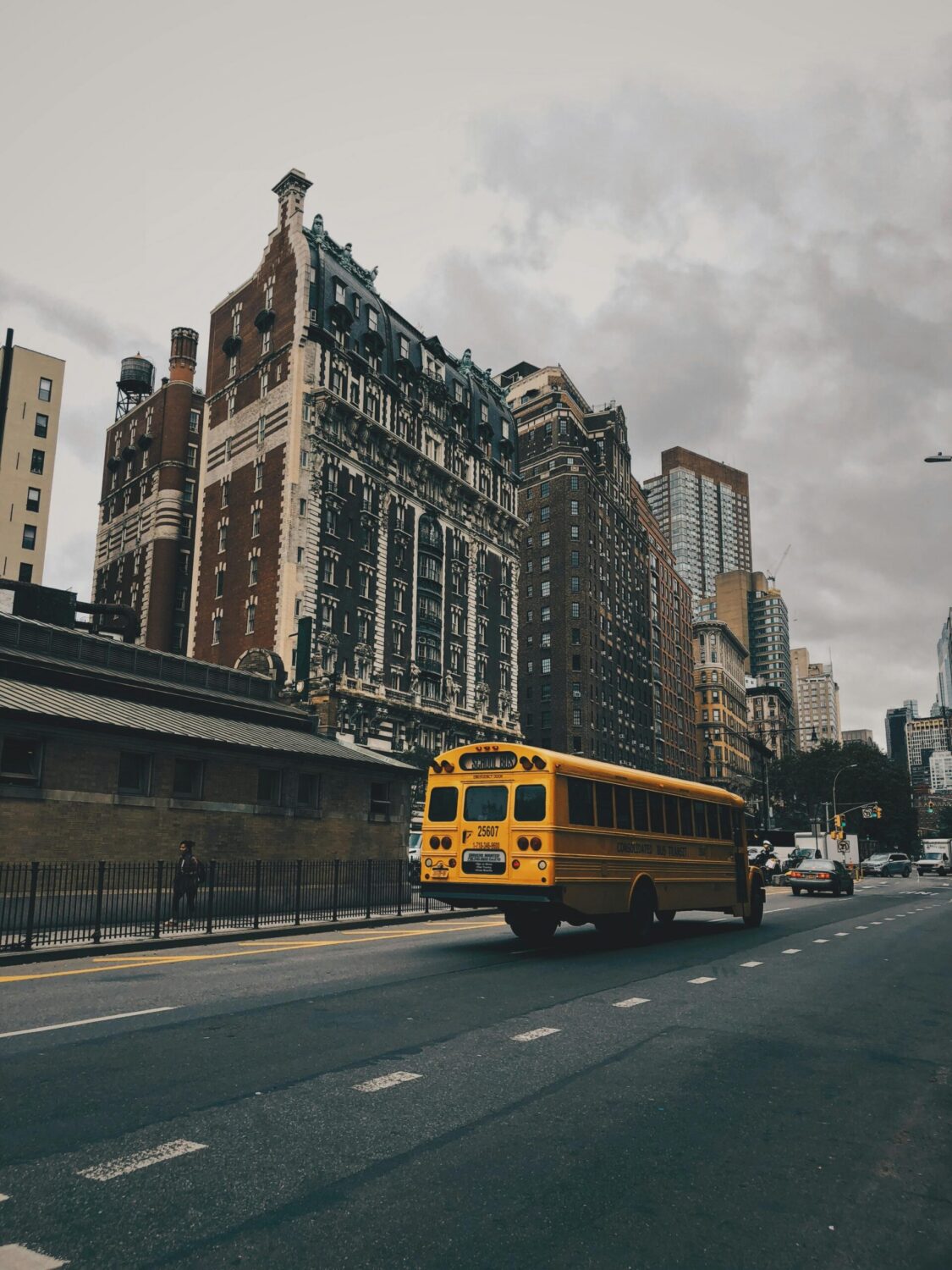 School bus drives down NYC street.