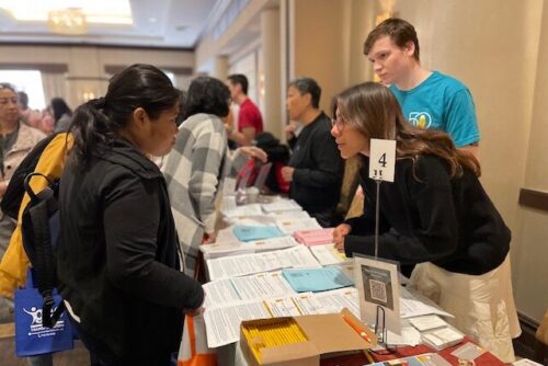 AFC staff speak to families at a resource fair